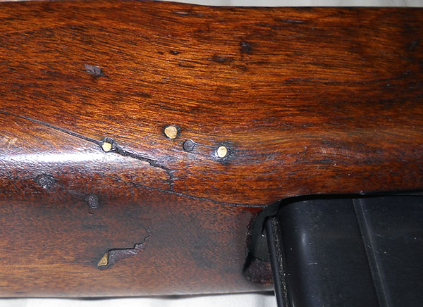 detail, closeup of repair to M1 carbine stock forward of magazine well